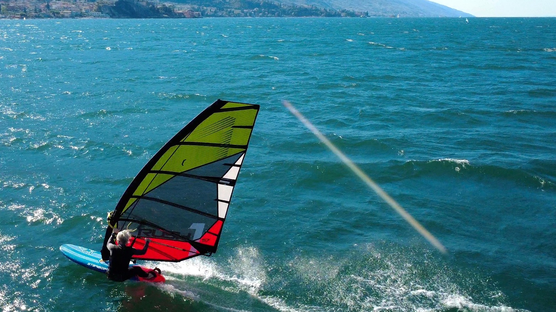 Rider carving a turn with a Point-7 Rush-1 sail.